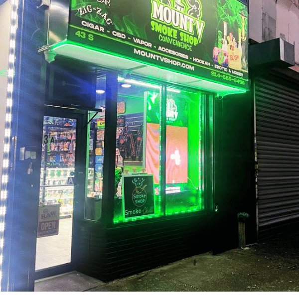 Open late sign with smoke shop in the background